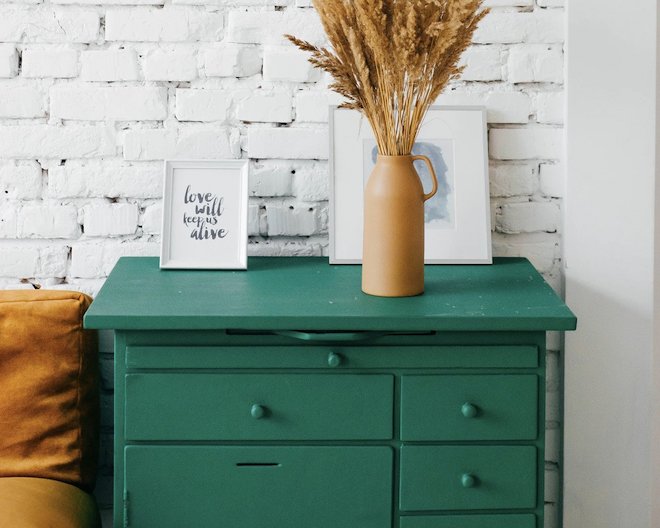 a set of drawers with a vase